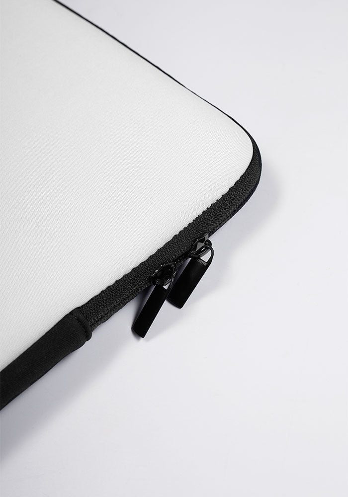 a close up of a zipper on a white laptop