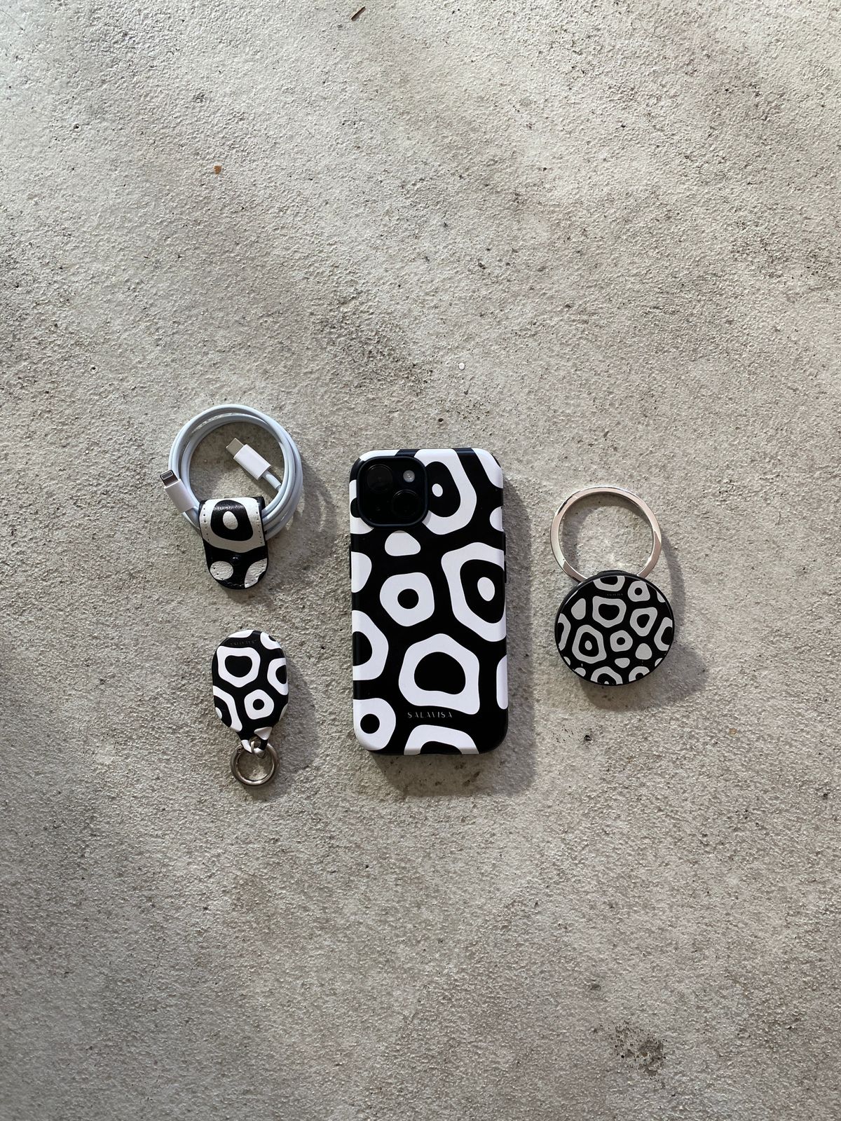 Salavisa matching accessories collection — AirTag cases, AirPods cases and cord organizers with original artwork